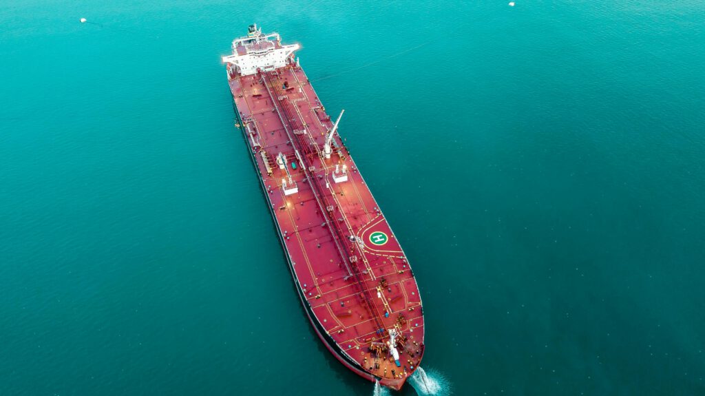Aerial shot of an oil tanker cruising through the ocean, emphasizing maritime transport.